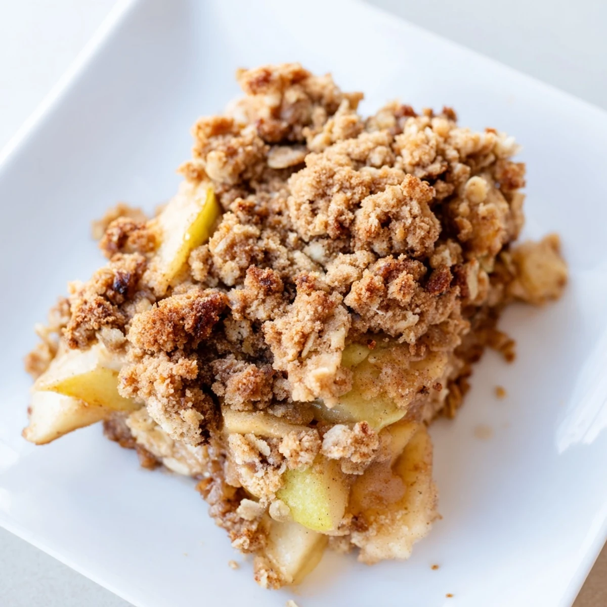 Enjoy a spoonful of the warm Rustic Apple and Cinnamon Crumb Bake, served with vanilla ice cream.