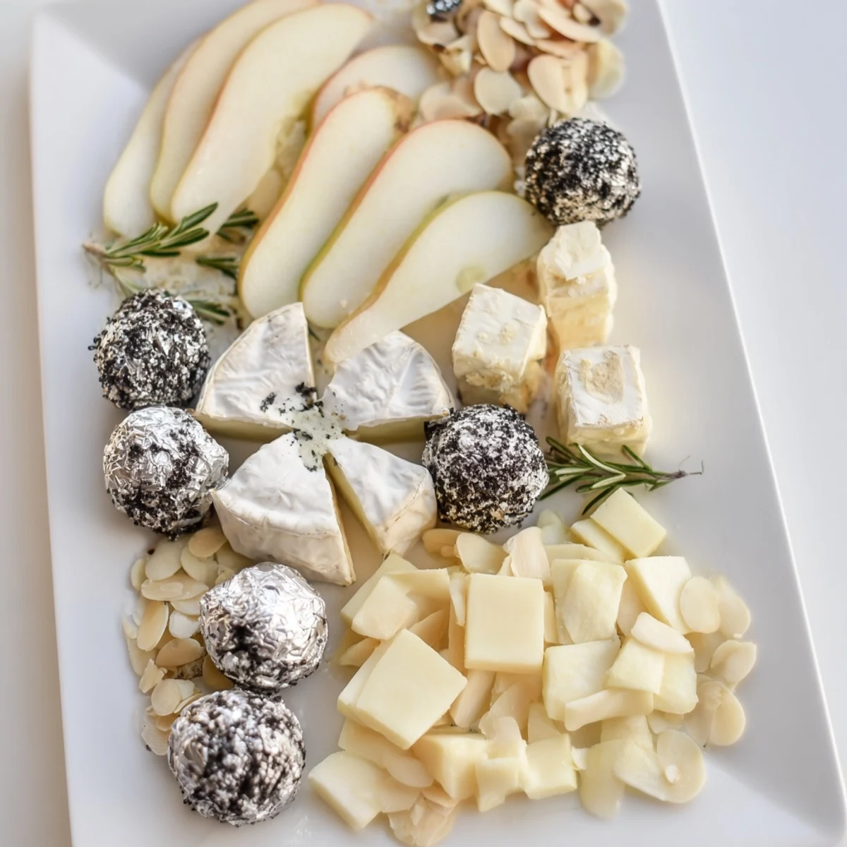 Elegant Silver Screen cheese board featuring creamy truffle brie and silver wrapped chocolates.