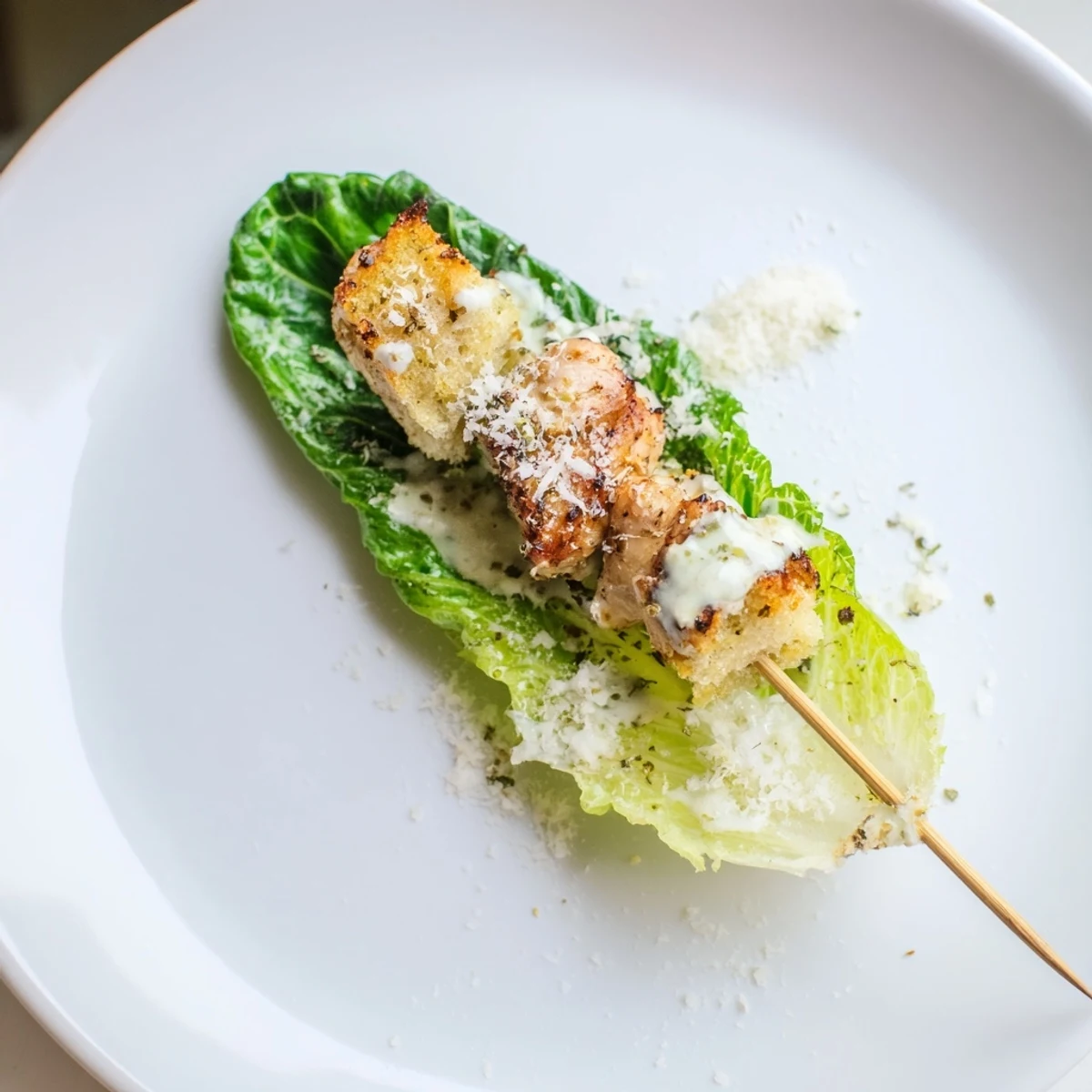 Grilled Chicken Caesar Salad Skewers, a delicious appetizer featuring chicken, romaine, and creamy Caesar dressing.