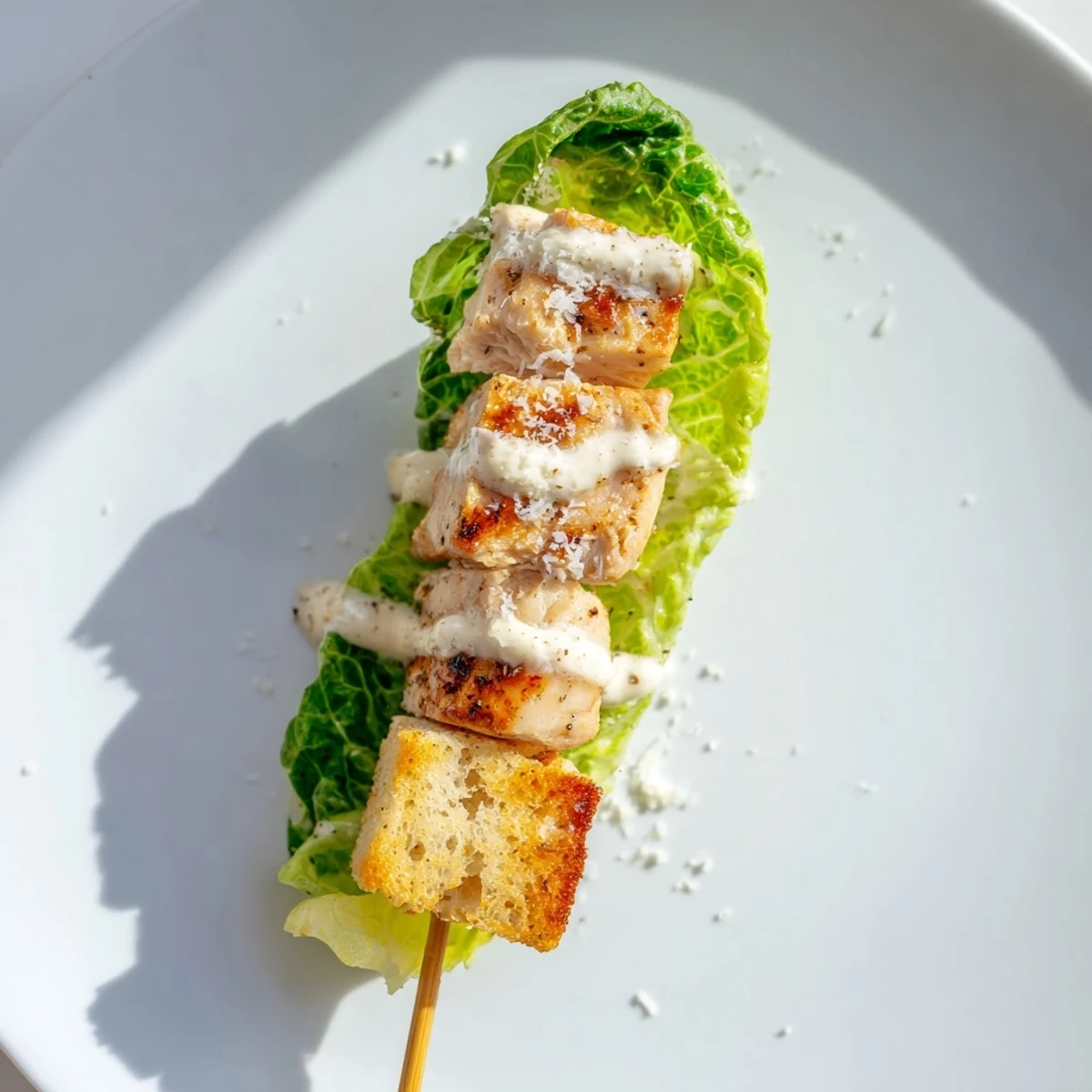 Enjoy the flavors of juicy grilled chicken and fresh Caesar Salad Skewers drizzled with dressing.