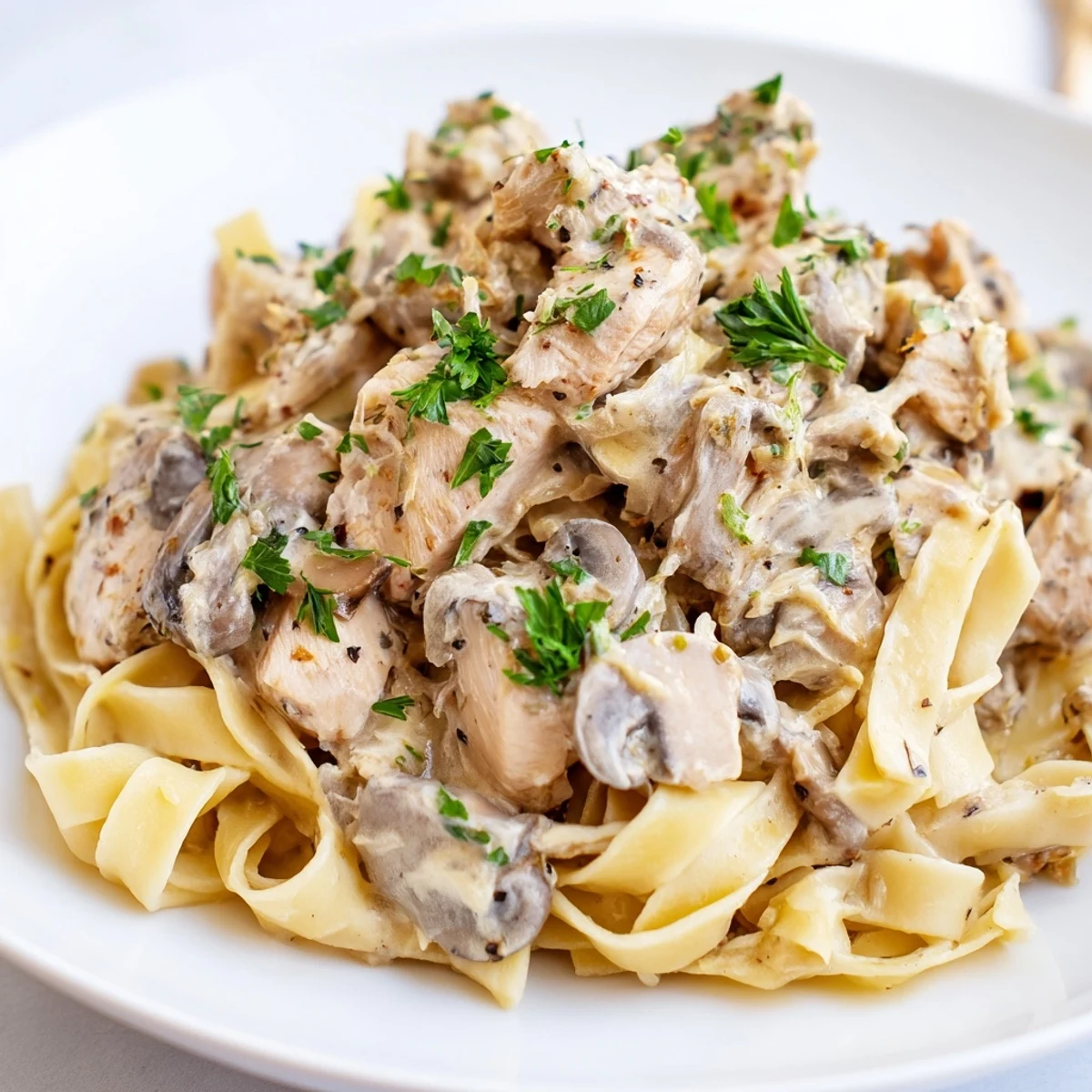 Creamy mushroom chicken pasta: A close-up of the dish shows tender chicken and perfect pasta.