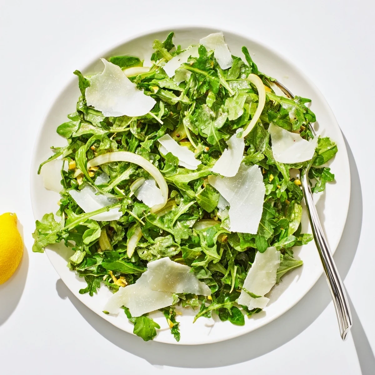 Fresh arugula salad with bright lemon dressing, Parmesan, and a burst of Italian flavors.