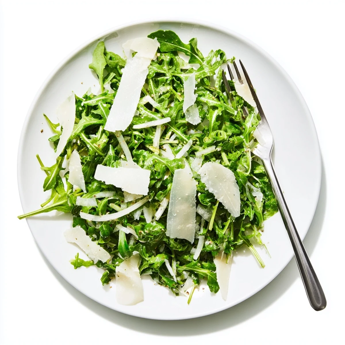 Tossed Arugula Salad with lemon dressing, easy to picture: leafy greens and shaved cheese, delicious.