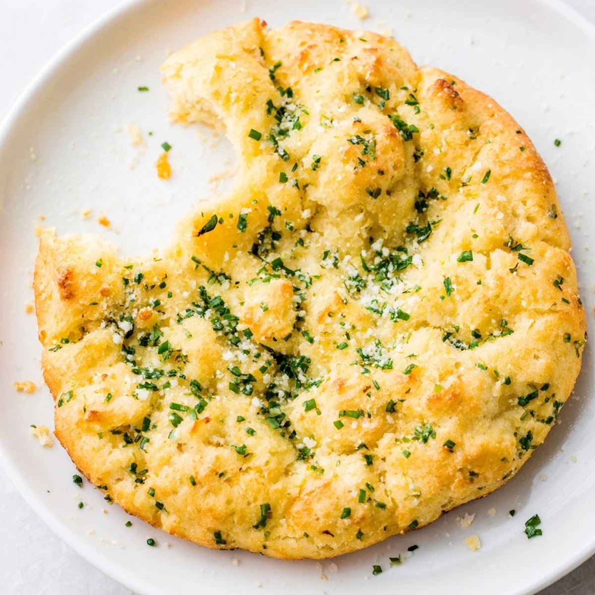 Golden brown cloud bread savory toast topped with fresh chives and parsley, perfect for dipping in marinara.