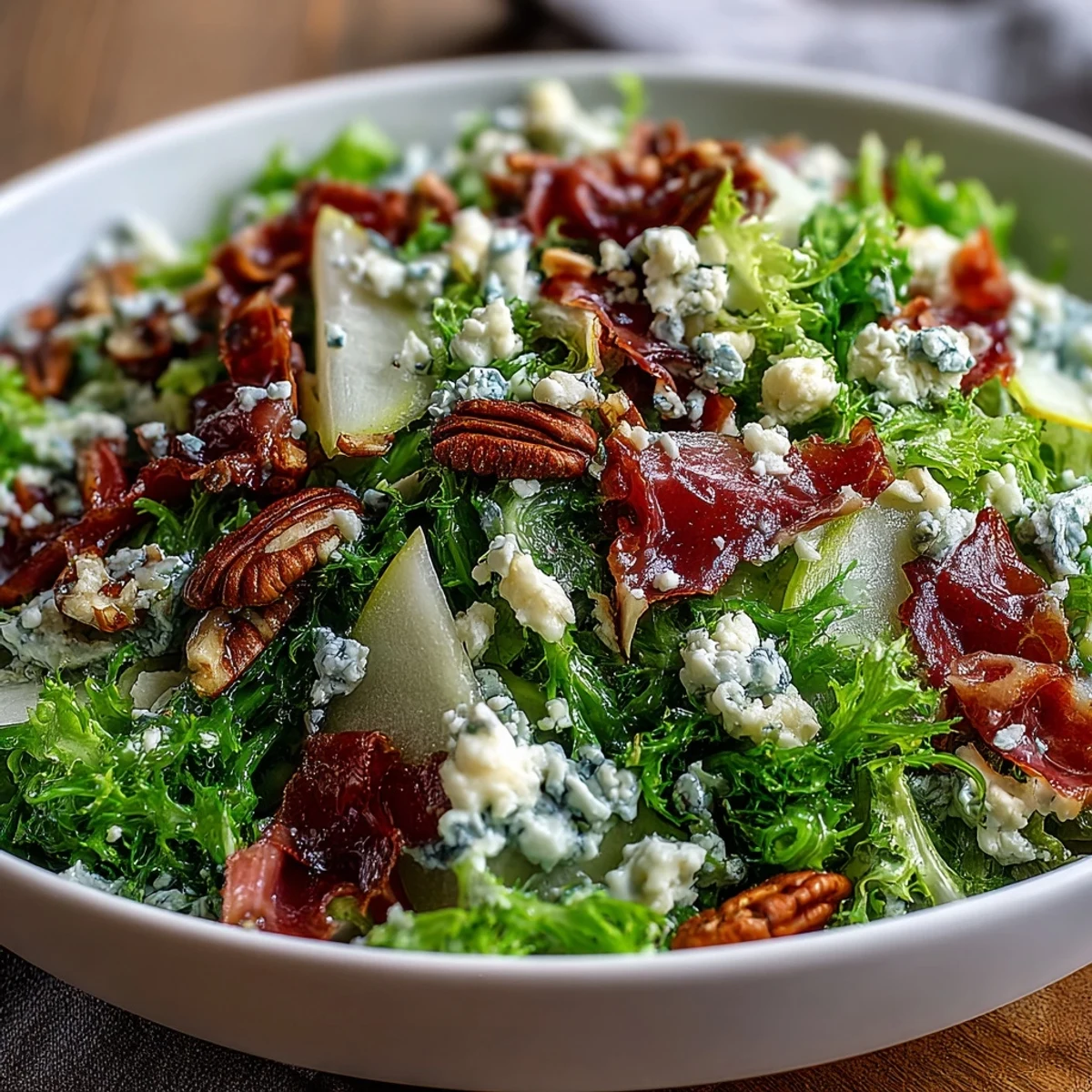 Frisée, Pear, Blue Cheese, and Crispy Prosciutto Salad with sweet pears and salty prosciutto.