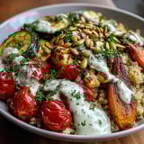 Vibrant Roasted Vegetable Quinoa Bowl garnished with toasted pumpkin seeds and chopped parsley, showcasing colorful medley of Mediterranean-inspired veggies.
