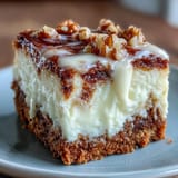 Moist carrot cake cheesecake bars with creamy swirls and crunchy walnuts, perfect for spring dessert platters.
