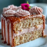 A visually striking pink velvet cake, boasting a delicate rosé rosé blush, adorned with a molten gold cascade.