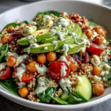 Vibrantly colorful Ancient Grains Bowl with creamy tahini dressing atop tender farro and quinoa.