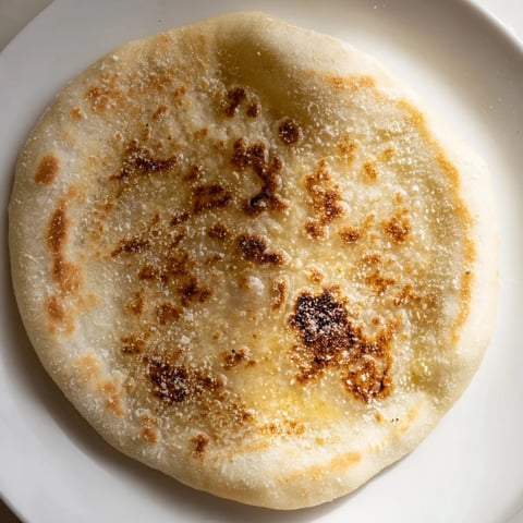 Golden-brown Three-Ingredient Easy Flatbreads, ready for serving with dips and spreads on a rustic wooden board.