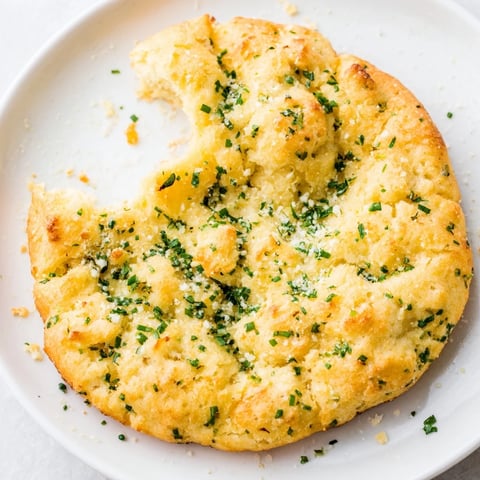 Golden brown cloud bread savory toast topped with fresh chives and parsley, perfect for dipping in marinara.