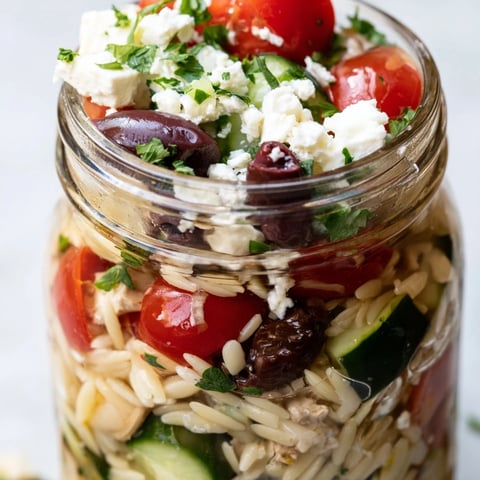 Bright Greek Pasta Chicken Salad Jars layered with orzo, juicy chicken, crisp cucumbers, and briny Kalamata olives for a fresh Mediterranean lunch.