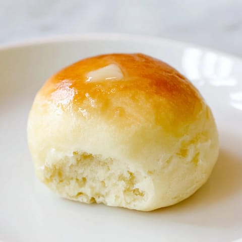 Fluffy and warm Quick-Rise Dinner Rolls, boasting a buttery golden crust you'll love.
