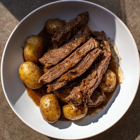 Fork-tender Simple 4-Ingredient Slow Cooker Pot Roast, smelling richly savory.