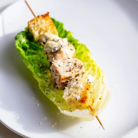 Skewer of Chicken Caesar Salad showcases grilled chicken alongside fresh romaine and crunchy croutons.