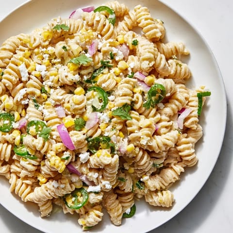 A bowl of Creamy Street Corn Pasta Salad: a colorful, chilled summer dish with fresh cilantro.