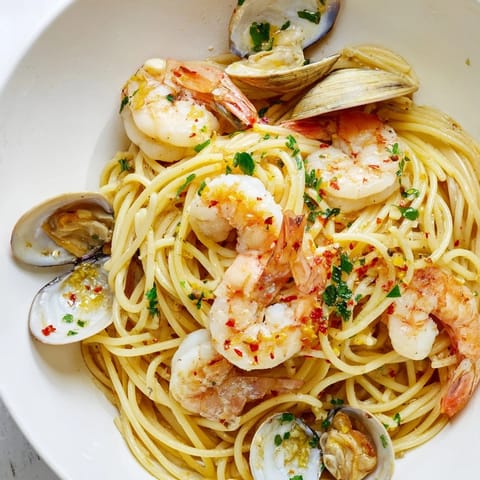Al dente spaghetti cradles the flavorful shrimp and clams in this gorgeous Seafood Pasta Aglio e Olio.