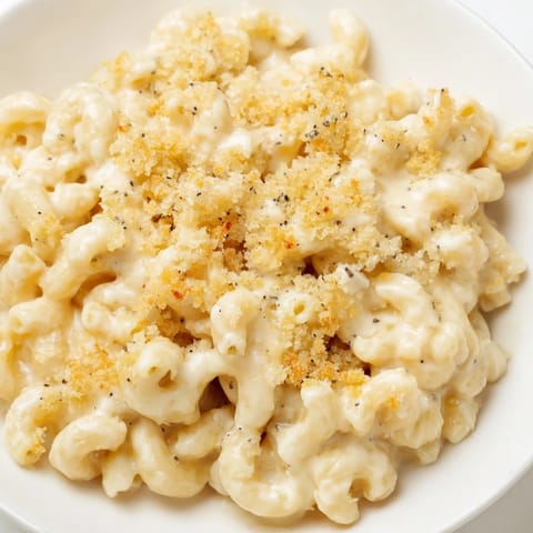 A close-up of creamy mac and cheese, showcasing the melted cheese and perfectly cooked macaroni.