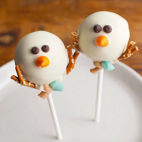 These festive Oreo Snowman Cake Pops feature chocolate chip eyes and a charming pretzel arm.