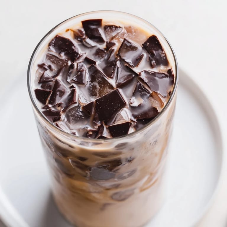 Cold, refreshing Chocolate Cracking Iced Latte: espresso, milk, and a delightful chocolate crackle for a sweet start.
