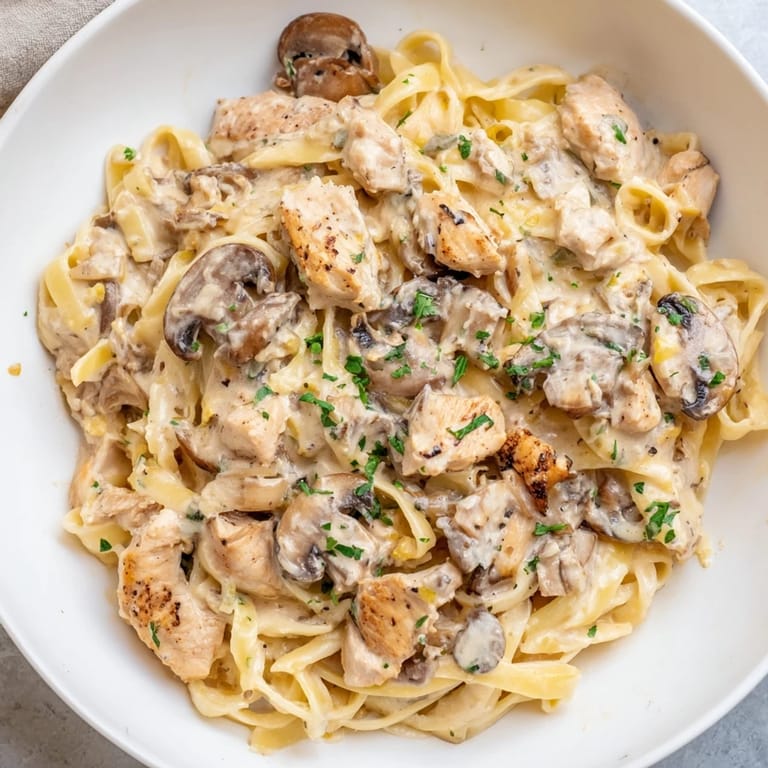 Golden chicken and mushrooms smothered in a creamy sauce over fettuccine, a delicious creamy mushroom chicken pasta.