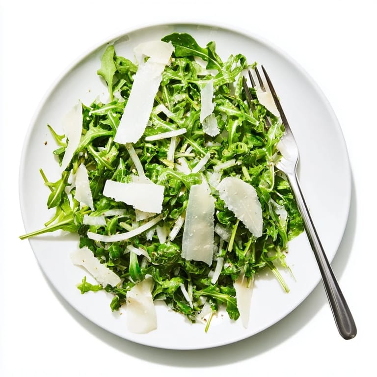 Tossed Arugula Salad with lemon dressing, easy to picture: leafy greens and shaved cheese, delicious.