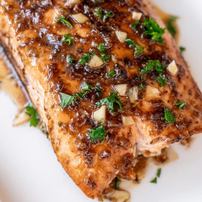 Ready to serve Honey Garlic Glazed Salmon, paired with lemon wedges and fluffy steamed rice.