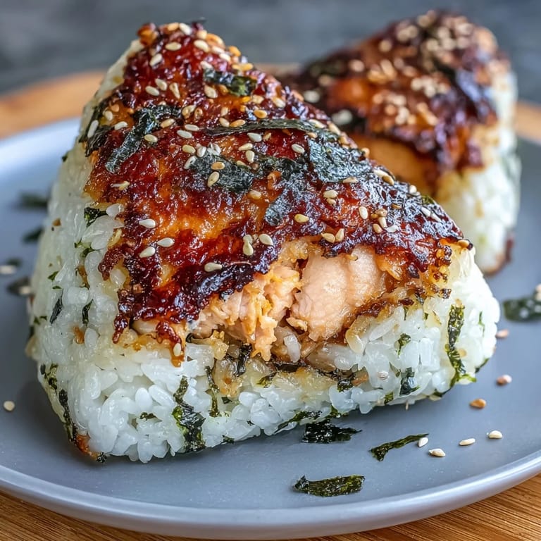 Freshly grilled salmon onigiri, a delicious Japanese rice ball, ready to enjoy.