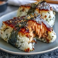 Golden grilled salmon onigiri, warm rice ball snack, perfectly crisp and savory.
